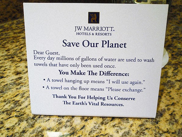Sign asking guests to reuse towels where possible to be more eco-friendly