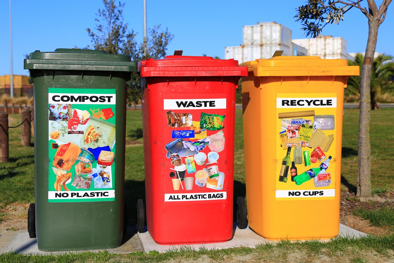 Clearly labeled recycling bins showing what waste goes where.