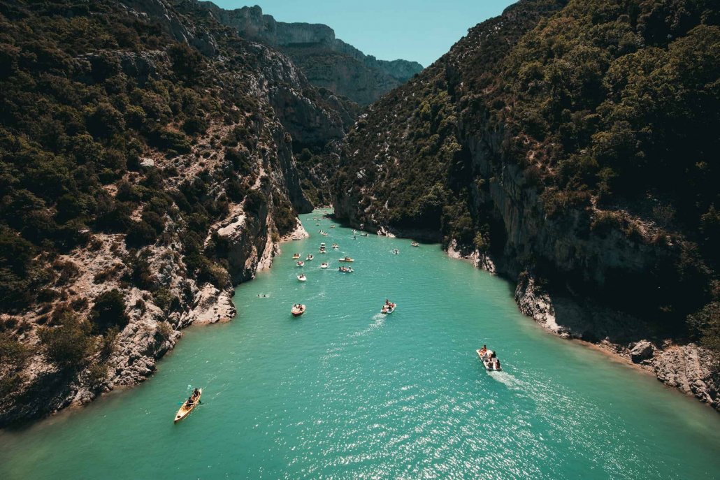 Kayakers going down a busy river during high season